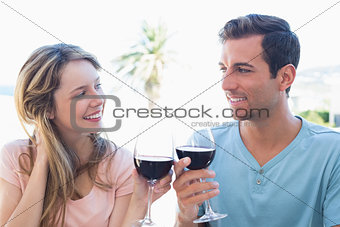 Young couple toasting wine glasses