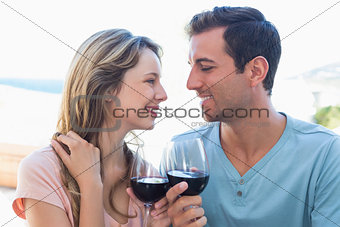 Loving young couple toasting wine glasses