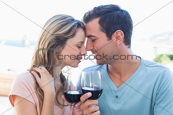 Loving young couple toasting wine glasses