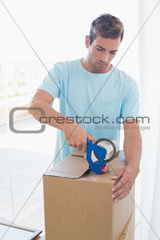 Man with cardboard boxes in new house