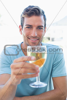 Smiling young man holding wine glass