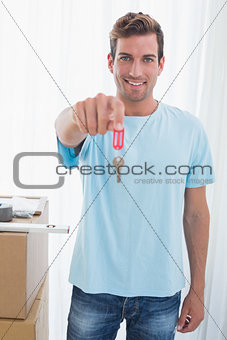 Happy man holding out new house key
