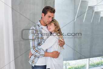 Loving young woman embracing man