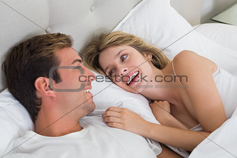 Relaxed young couple resting in bed