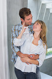 Loving young man embracing woman from behind