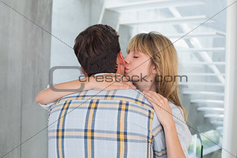 Close-up of a loving woman kissing man