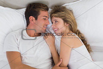 Relaxed couple resting together in bed