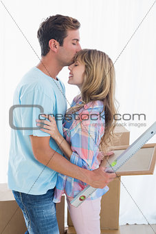 Young man kissing womans forehead