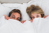 Relaxed young couple together in bed