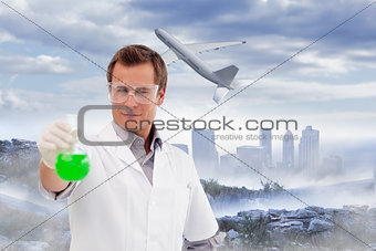 Composite image of young scientist working with a beaker
