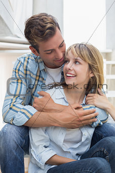 Loving young man embracing woman