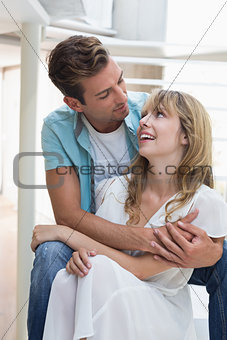 Loving young man embracing woman