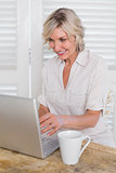 Mature woman using laptop at home