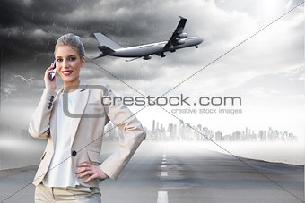Composite image of cheerful elegant businesswoman on the phone