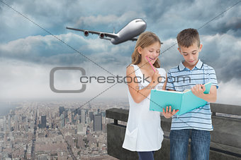 Composite image of concentrated brother and sister learning their lesson together