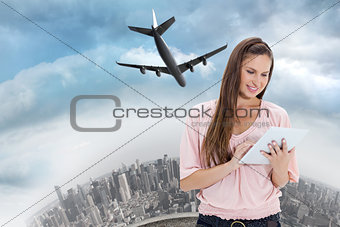 Composite image of close up of a girl using a touchpad