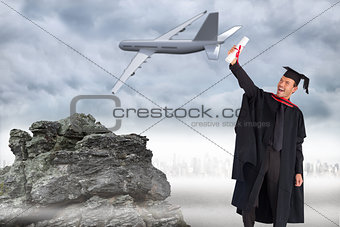 Composite image of delighted boy celebrating his graduation