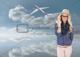 Composite image of serious trendy blonde on the phone