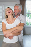 Mature man embracing woman from behind