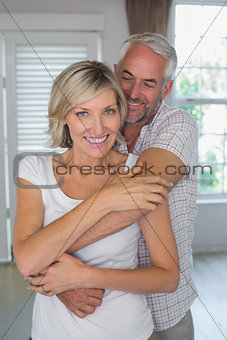 Mature man embracing smiling woman