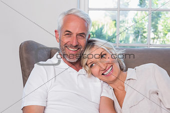 Portrait of a smiling mature couple sitting on sofa