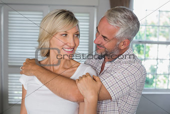 Mature man embracing a happy woman
