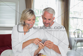 Couple reading text message at home