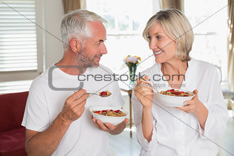 Loving mature couple having breakfast at home