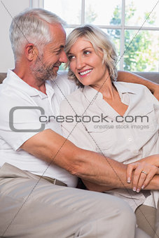 Mature couple looking at each other in living room