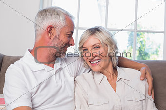 Relaxed happy mature couple sitting on couch