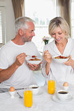 Happy mature couple having breakfast