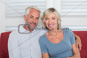 Portrait of smiling mature couple on couch
