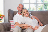 Portrait of a relaxed mature couple sitting on couch