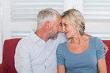 Relaxed mature couple sitting on couch