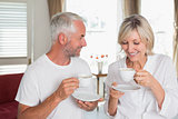 Smiling mature couple with coffee cups
