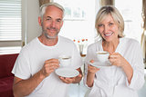Portrait of smiling mature couple with coffee cups