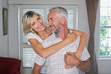 Portrait of a smiling woman embracing mature man
