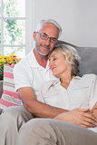 Portrait of a relaxed mature couple sitting on sofa
