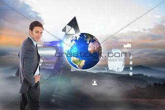 Composite image of cheerful businessman standing with hands on hips