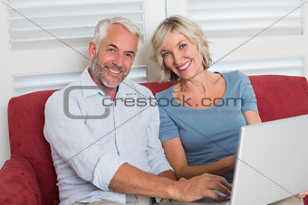 Portrait of a casual mature woman using laptop at home