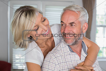 Close-up of a happy woman embracing mature man
