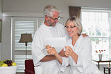 Mature couple looking at a document at home
