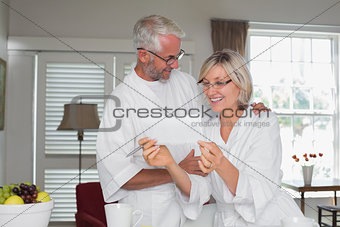 Mature couple looking at a document at home