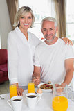 Mature couple having breakfast at home
