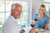 Portrait of a mature couple with wine glasses having food