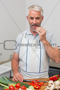 Mature man chopping vegetables in kitchen