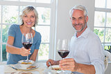 Mature couple with wine glasses and food