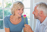 Happy mature couple with a flower