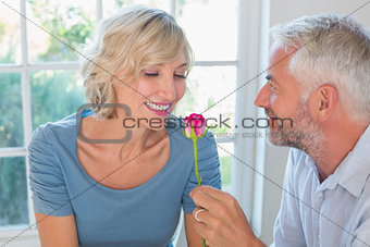 Happy mature couple with a flower