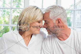Close-up of a relaxed mature couple with eyes closed at home